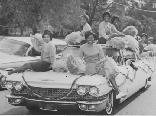 Historical Photo of young women on a car in a parade