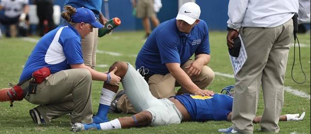 ASU Sports Medicine professionals tending to an injured football player.