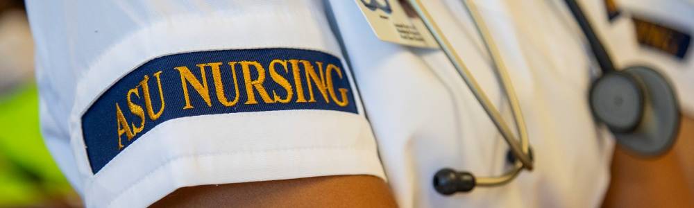 Image of nursing student in uniform, displaying the armband reading "ASU Nursing"