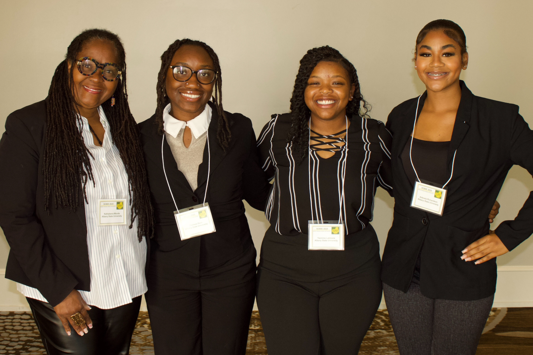 3 students from ASU smiling alongside faculty advisor