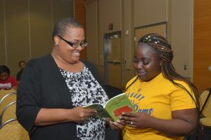 Bummi Niyonu Anderson reviews poetry material with an ASU student.